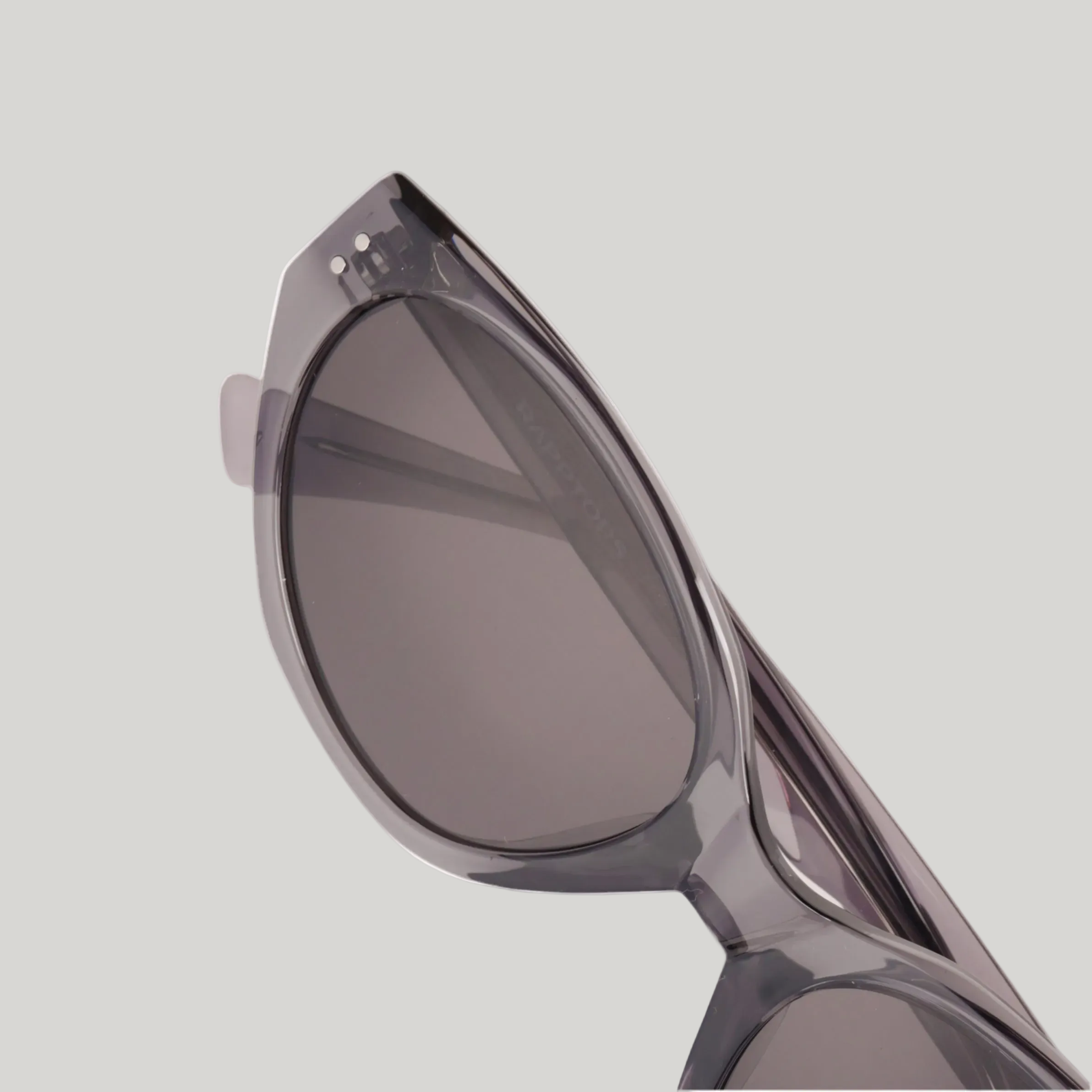 Sunglasses with a gray frame and dark lenses on a white background