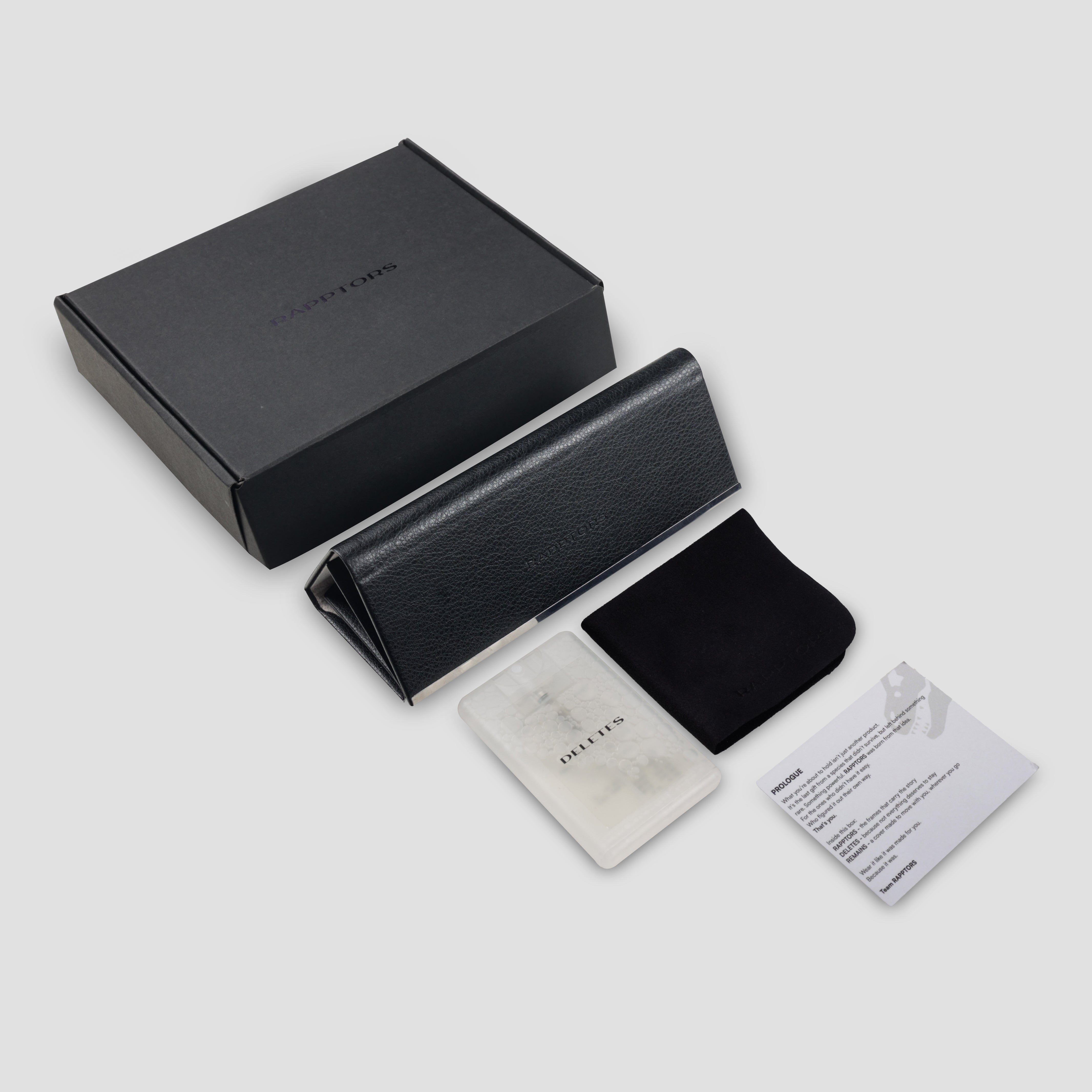 Black leather wallet with accessories on a light gray background