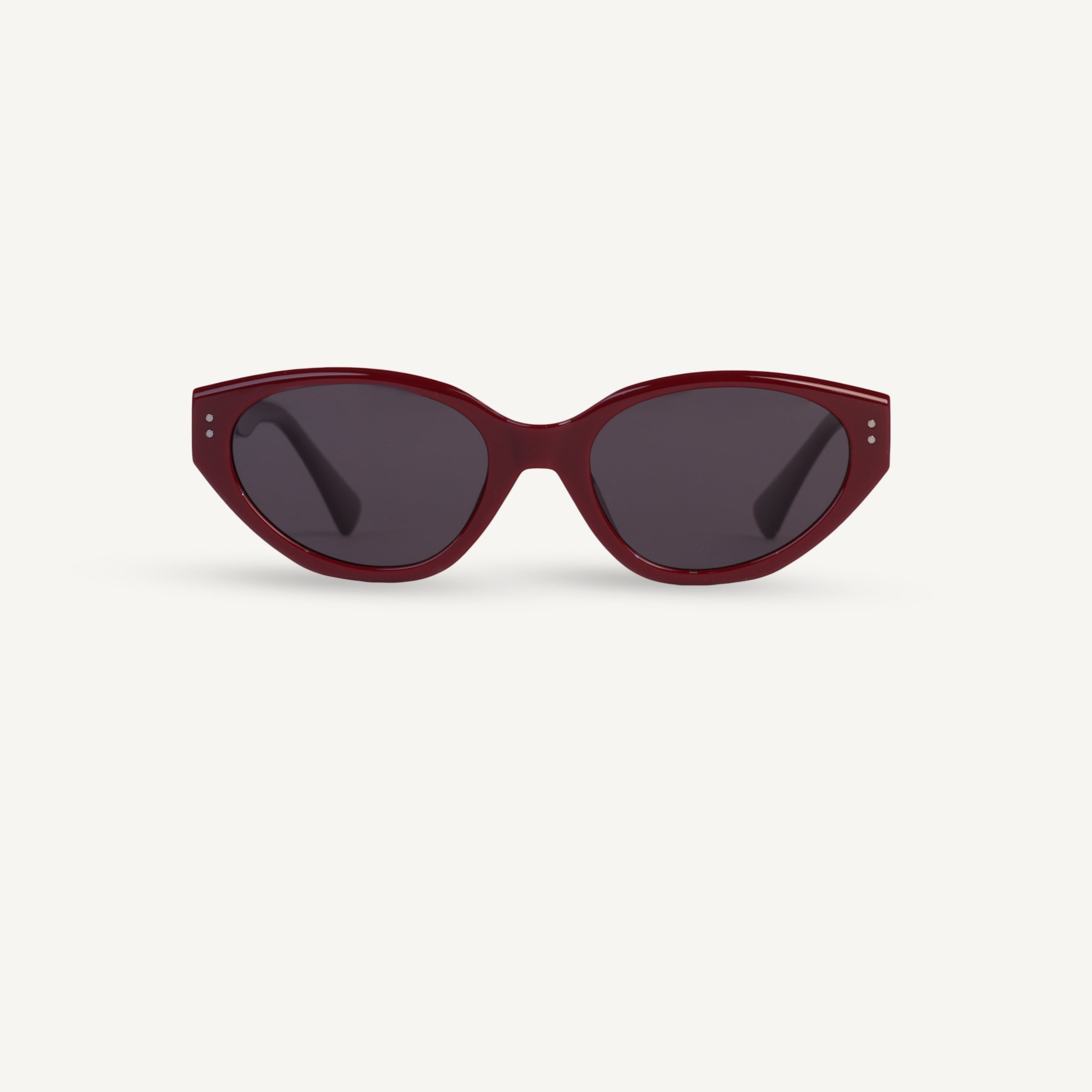 Red sunglasses with dark lenses on a white background