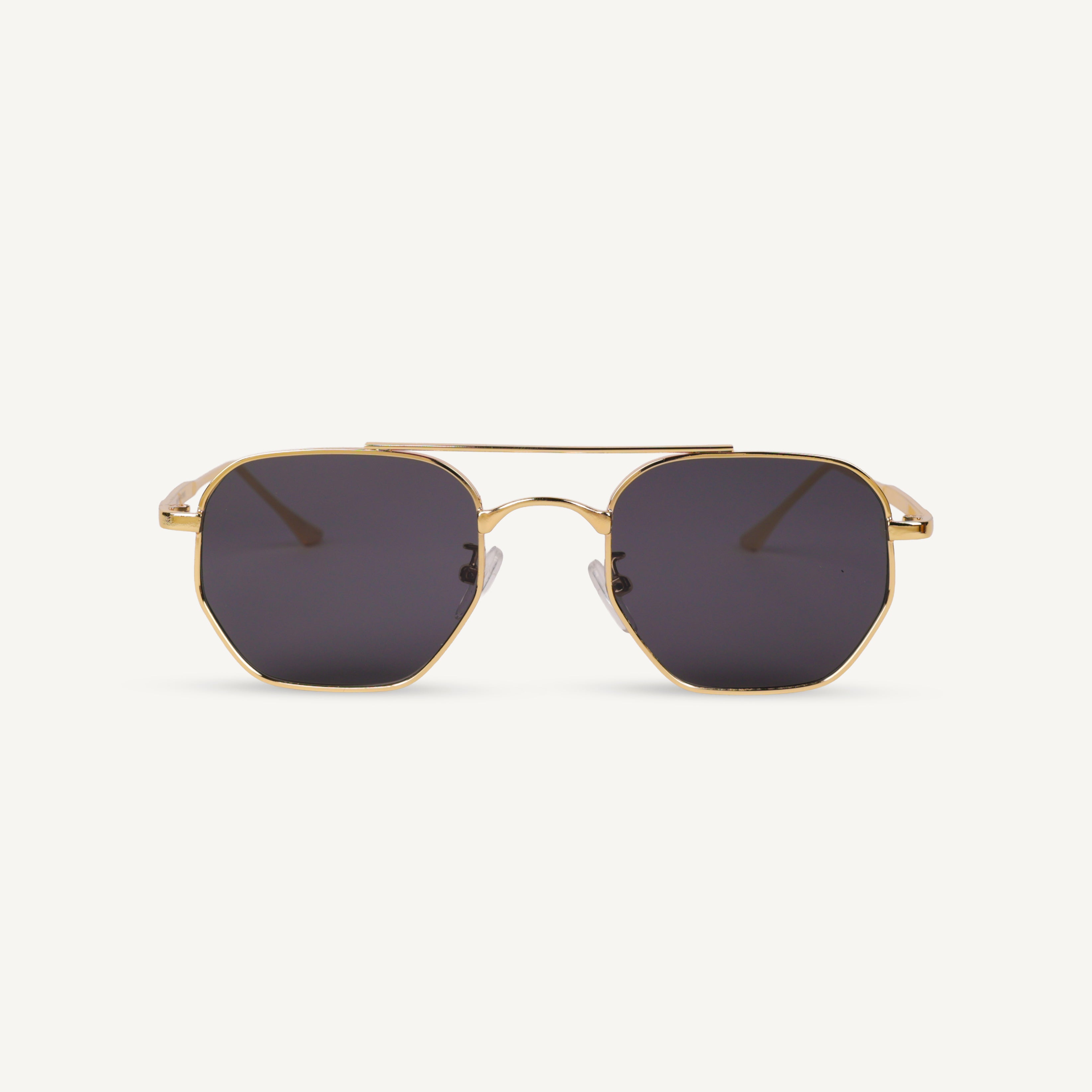 Gold-framed sunglasses with dark lenses on a white background