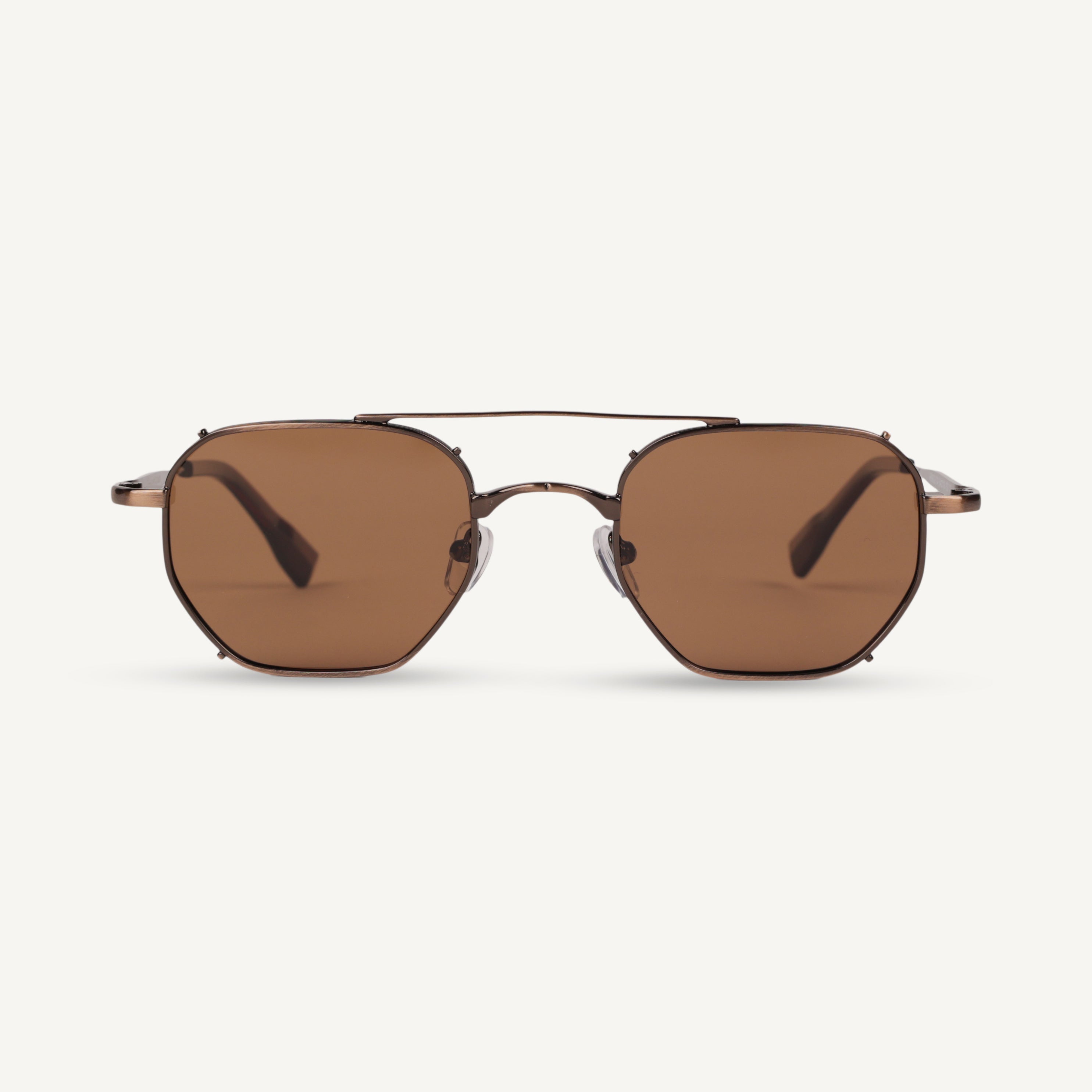 Sunglasses with brown lenses and gold frame on a white background