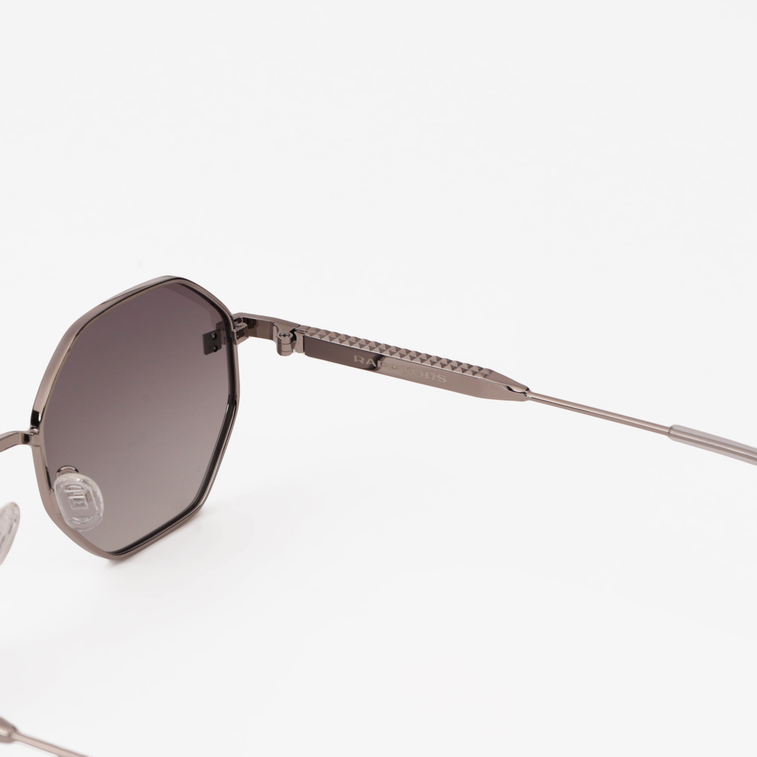 Sunglasses with a hexagonal frame and dark lenses on a white background