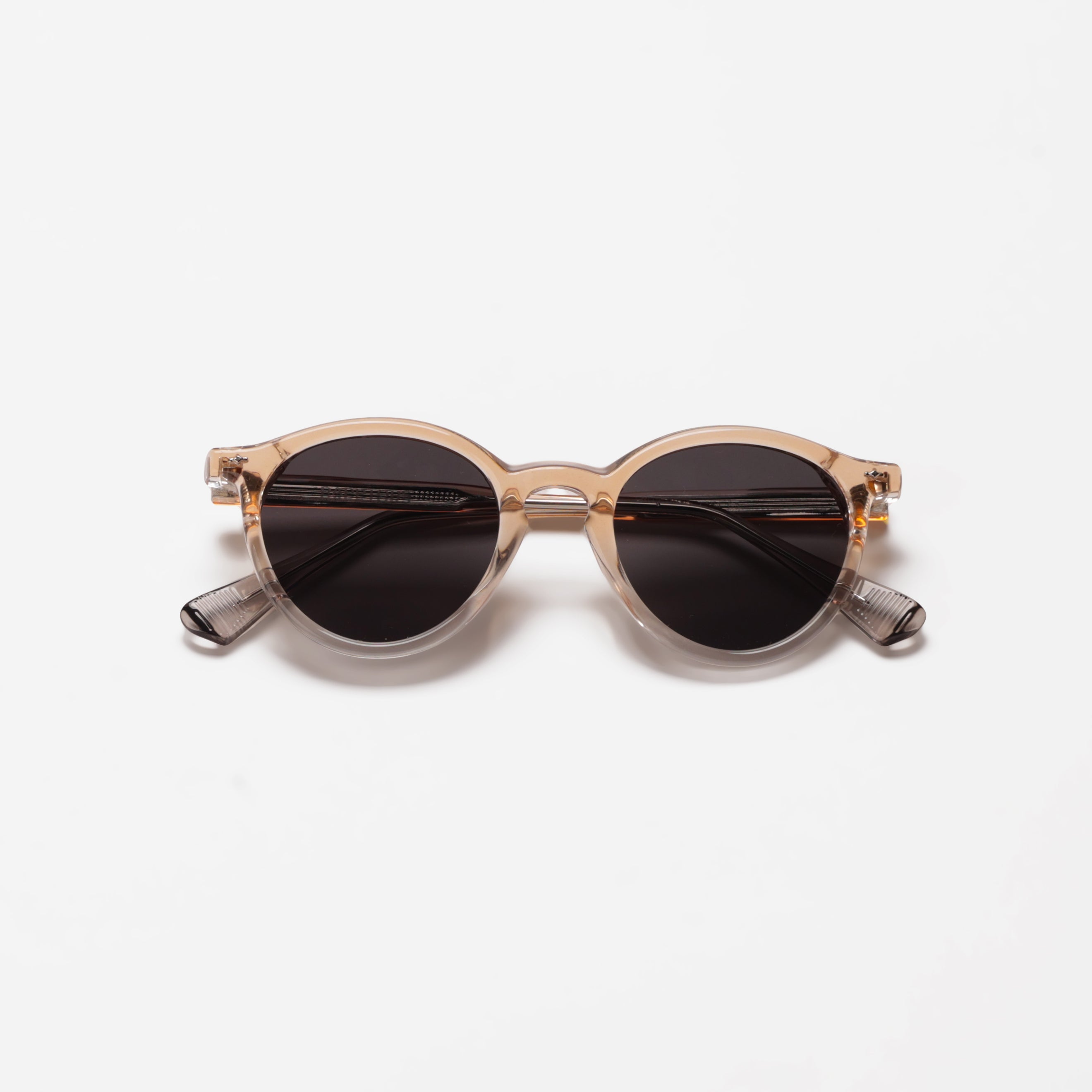 Round sunglasses with a clear frame on a white background