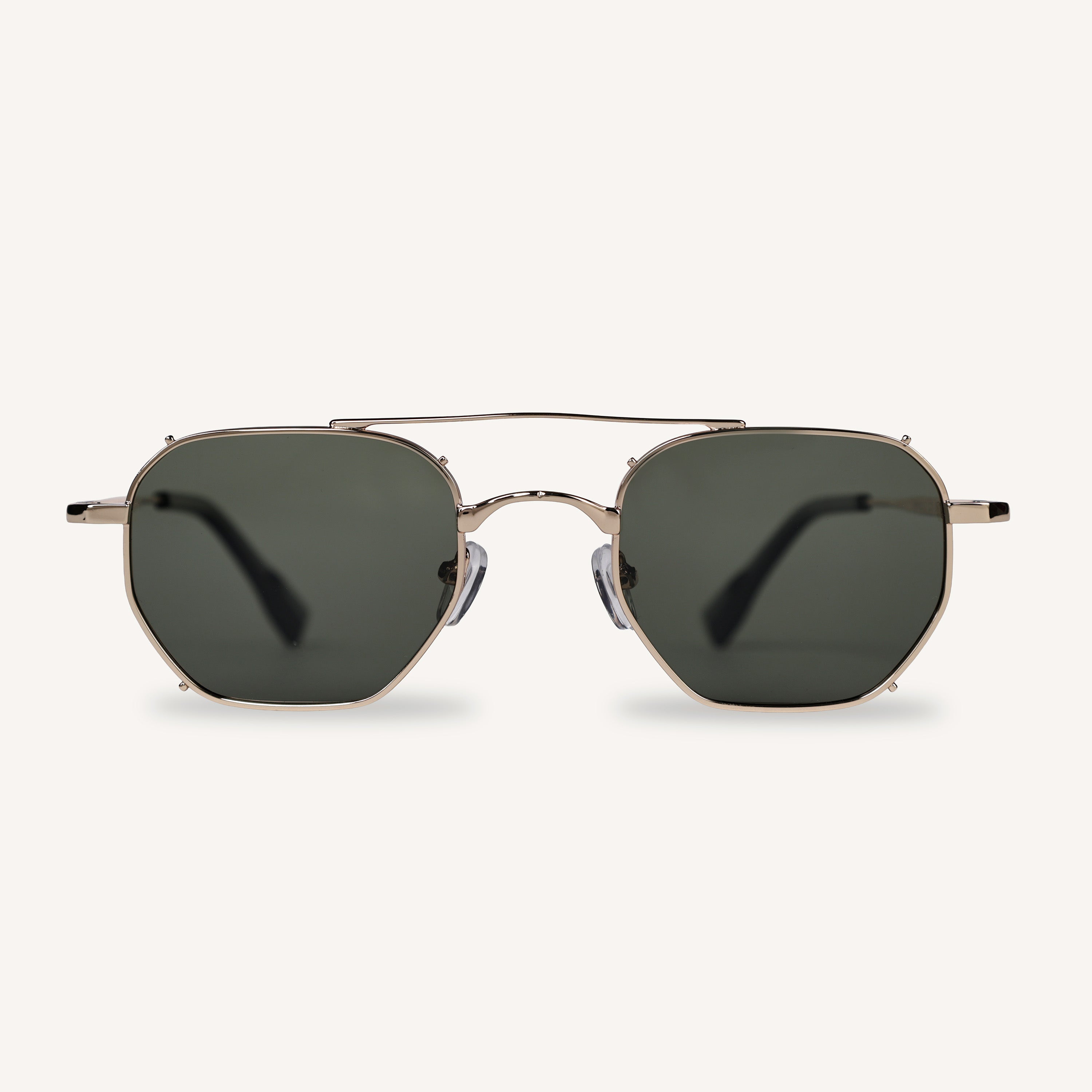 Golden frame sunglasses with green lenses on a white background